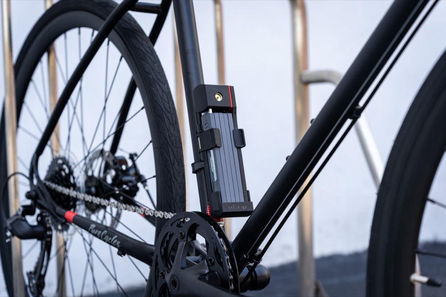 A Securit Bronto folding link lock mounted to the down tube of a road bike.